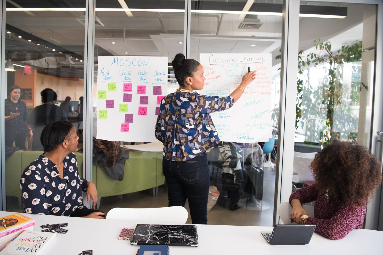 Black professionals collaborating at whiteboard