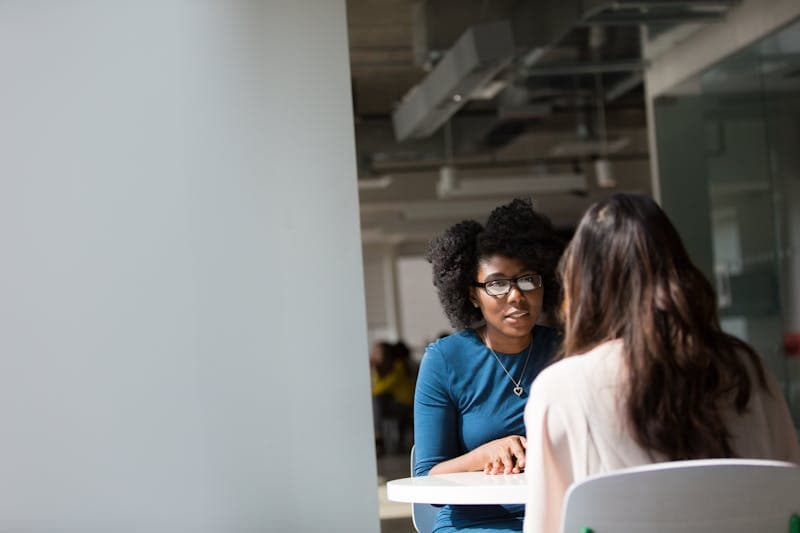 Black professional in conversation